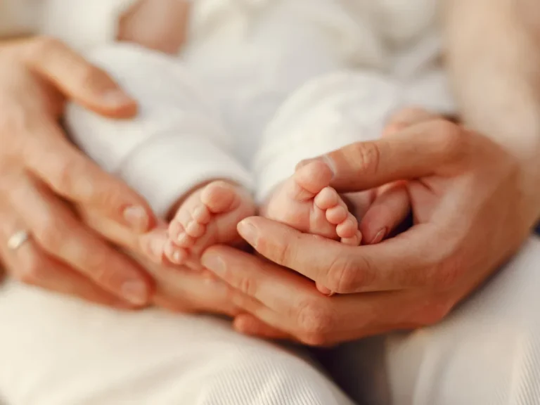 Baby's feet in mother's hand